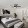 Two-BR Apartments in Fort Myers, FL - The Lennox - Bedroom with Carpet Flooring, a Lighted Ceiling Fan, a Large Window, Stylish Decor, and a Bathroom